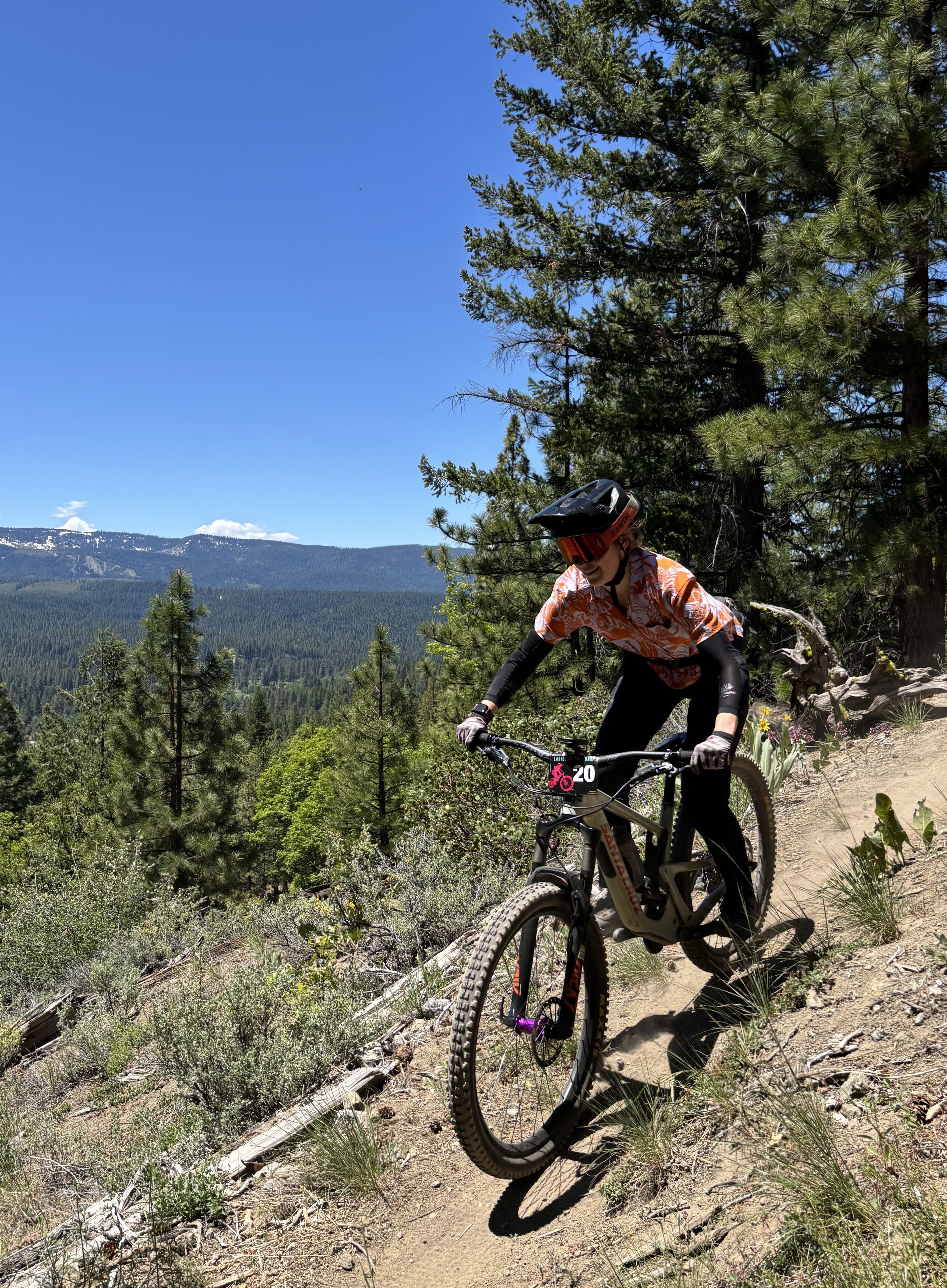 Coach riding mountain bike on a trail